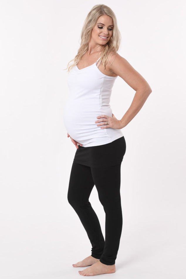 Pregnant woman wearing a skinny Skirt Maternity Yoga Pants Duo in black front