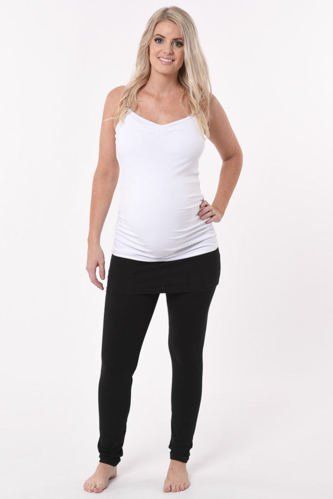 Pregnant woman wearing a skinny Skirt Maternity Yoga Pants Duo in black front view