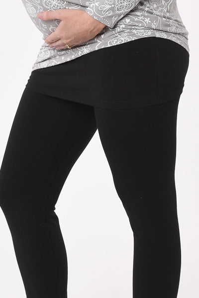 Pregnant woman wearing a skinny Skirt Maternity Yoga Pants Duo in black close-up